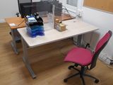 a desk with a chair and a computer on it
