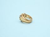 a gold ring with a diamond on it on a blue surface