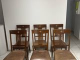 several chairs and stools in a room with white tile flooring