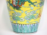 a vase with a dragon on it sitting on a table