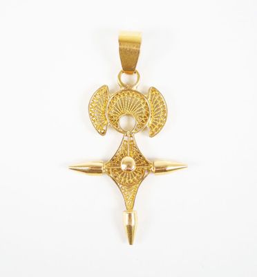 an image of a gold pendant with a cross on it