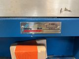 a close up of a blue machine with orange tape on it