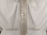 a white sheet wrapped around a tall vase on a white surface