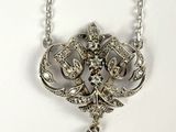 an image of a silver necklace with a bird on it
