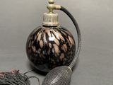 a black and brown bottle with a tassel on it