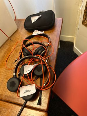 a table with headphones and a bag on top of it