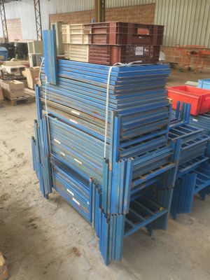 des palettes en acier bleu empilées les unes sur les autres dans un entrepôt
