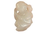 une image représentant une figurine en jade blanc posée sur une surface blanche