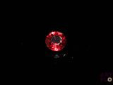 a close up of a red diamond on a black background