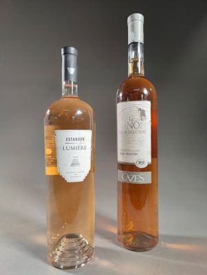 two bottles of wine sitting next to each other on a table