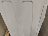 a white washer sitting on top of a pallet in a warehouse