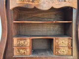 a wooden cabinet with drawers and a mirror on it
