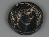 an ancient coin with a woman ' s face on it