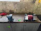 un établi en béton sur lequel sont posés des outils, dans une pièce