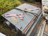 a metal box that has a pair of scissors on top of it