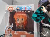 anime figurines are displayed on a glass shelf in a display case