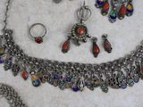 a necklace, bracelet, ring, and earring set on a table