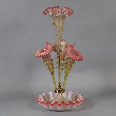 a glass vase with pink flowers in it on a table