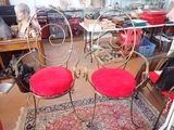 two chairs that have red cushions on them in a room