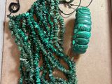 necklaces and bracelets are displayed in a box on a table