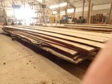 many pieces of wood stacked up in a warehouse