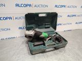 a tool in a green case sitting on top of a table