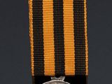 an image of a medal with a cross on it and a coin