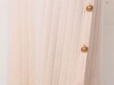 a close up of a white sweater with buttons on it