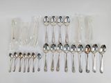 a lot of silver spoons and spoon spoons on the table