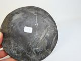 a person holding a rock with a sticker on it