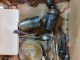 a box full of silverware and spoons and utensils