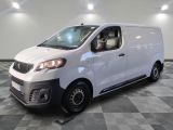 la camionnette blanche est garée dans une grande pièce au sol en damier