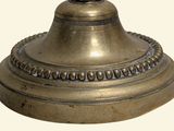 a small bell on top of a table on a white background
