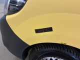 a close up of a yellow car with a sticker on it