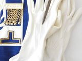 an image of a blue and white apron with a pair of white gloves and a pair of white gloves