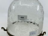 a glass clochet that has a label on it