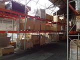 many boxes on the shelves in the warehouse