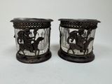 two vases that have horses on them on a table