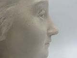 a white statue of a woman with a bird in her hand