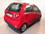 a red car that is parked in a room
