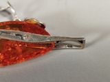 a pair of scissors sitting on top of a piece of jewelry