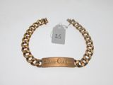 a close up of a chain bracelet with a tag on it