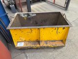 a yellow dumpster sitting on the side of the street