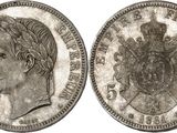 a silver coin with a woman ' s head and a crown on it