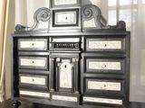 a black and white dresser with drawers on a table