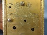 a gold clock with a dragon on it on a table