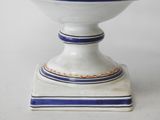 a white bowl with a blue and white stripe on it