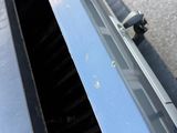 a close up of a car ' s front bumper with a window open