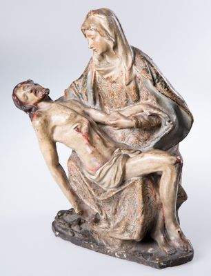 a statue of jesus holding the head of a woman
