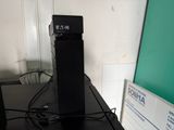 a clock on top of a black table next to a computer